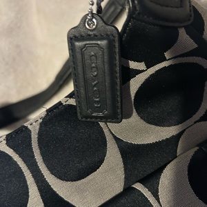 Coach purse black and tan with 3 compartments. New without tags, never used!